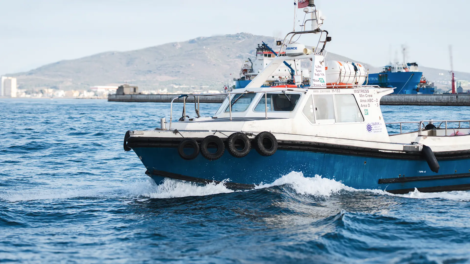 Tarik pilot boat underway with a tanker in the background