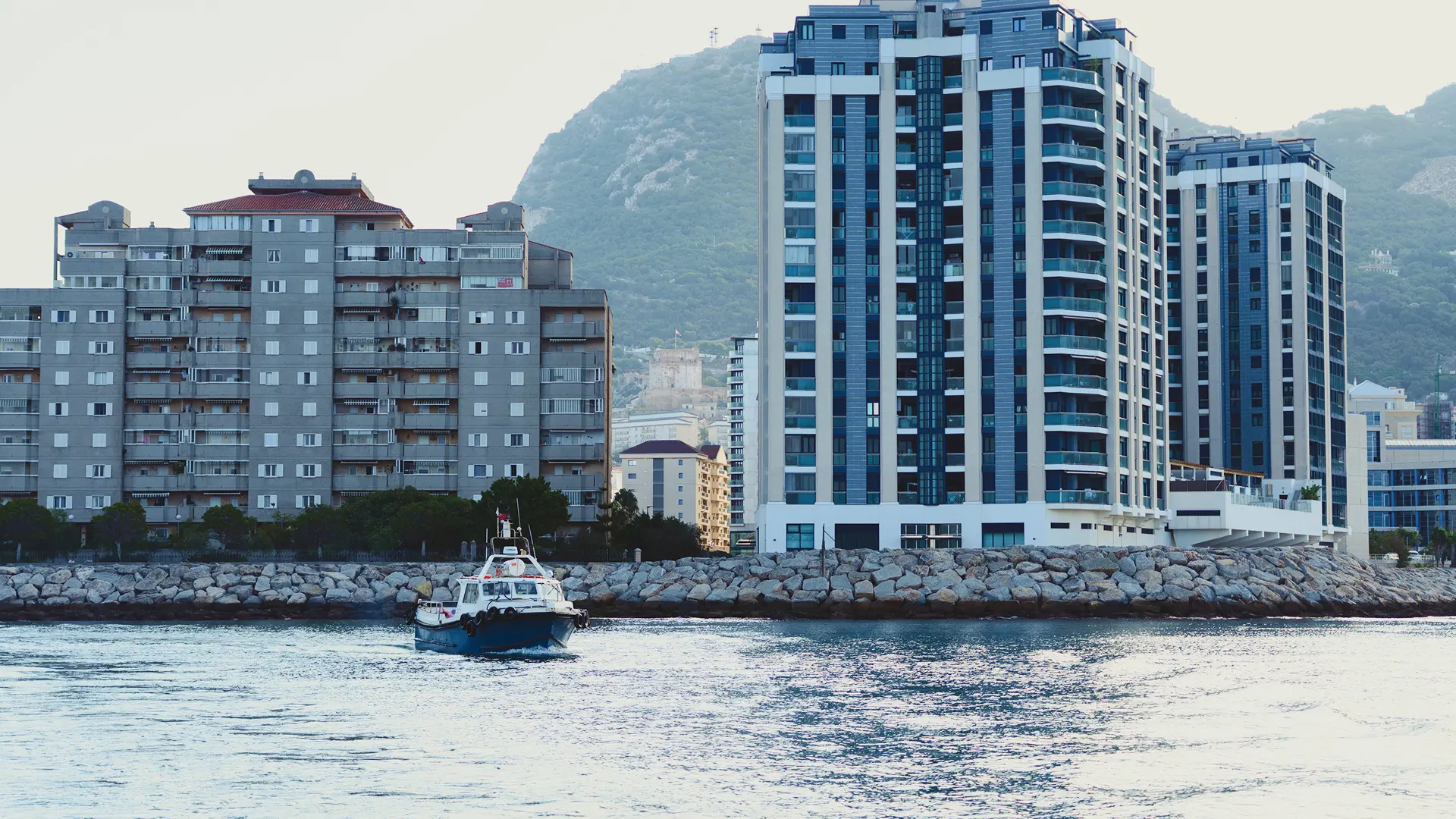 Tarik workboat passing Gibraltar's residential waterfront